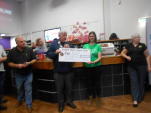 Cheque being presented to the charity ELF