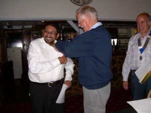 Lion Clif Cane pinning Lion Membership bdge onto new Lion James Lion Clif Cane pinning Lion Membership bdge onto new Lion James