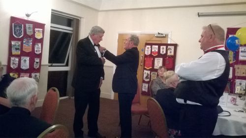 Lion Mike Mitchell receiving his Melvin Jones Fellowship Badge from DG Elect Peter Rowe