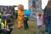 Lion Twiggy Lake being fitted with harness,to climb the tower