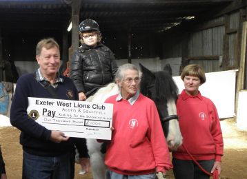 Past President Dr Alan Benson presents cheque