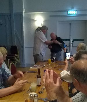 Pinning President's badge on Lion David Lyon