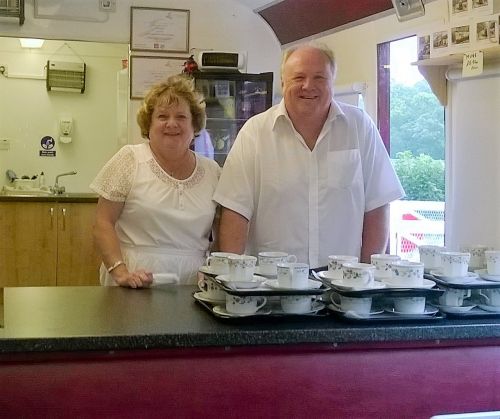 Lion Sue Bates and husband Steve at serving bar in railway cafe coach